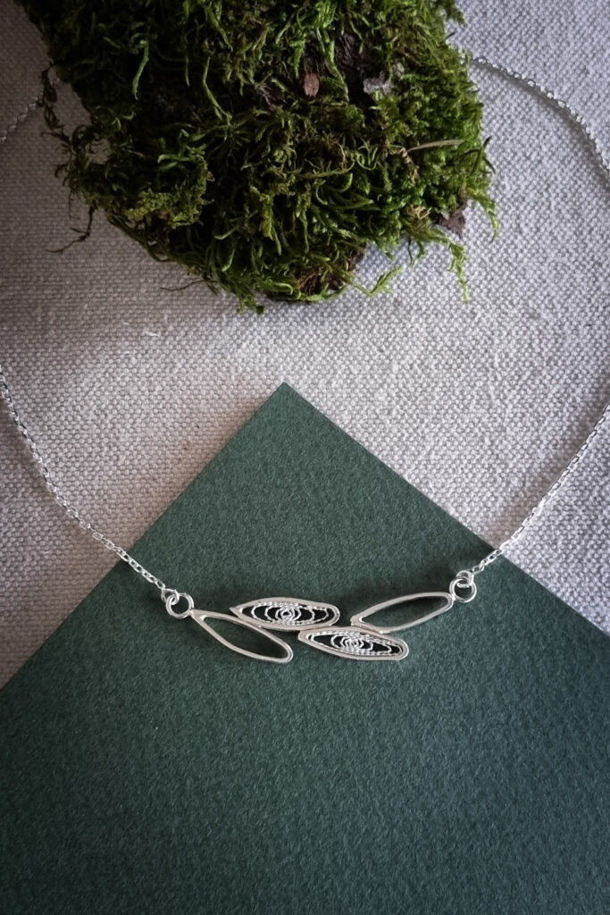 collier en argent avec en son centre un motif de feuilles simple contour ou remplies de filigrane